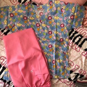 Two pairs of new extra small scrubs ( printed top scrubs and plain pant scrubs)
